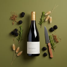 Load image into Gallery viewer, A bottle of Sam Harrop Onetangi Waiheke Island syrah wine surrounded by blackberries, herbs, and a knife on a green background