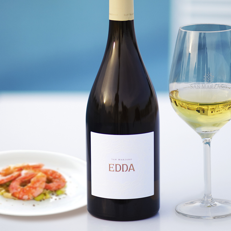 Load image into Gallery viewer, A bottle of white wine, glass of wine and a prawn dish with a blue background
