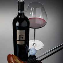 Load image into Gallery viewer, San Marzano F Puglia Negroamaro wine bottle, glass with red wine, golf club, and golf ball on a reflective surface