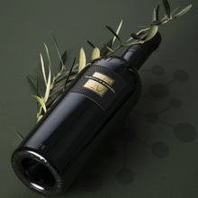 Load image into Gallery viewer, Black wine bottle with olive branch on a dark background