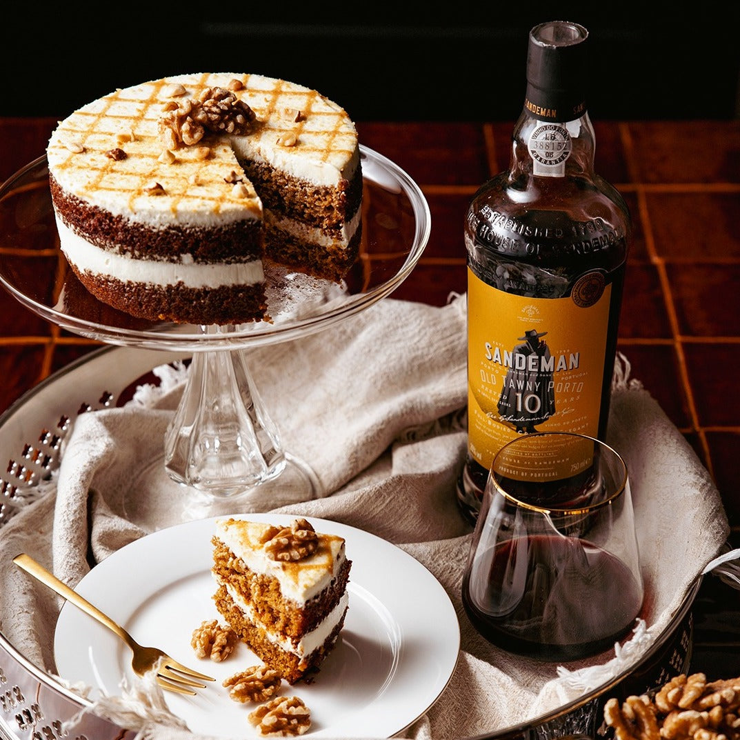 Load image into Gallery viewer, A bottle of Sandeman 10 year old port wine on a tray with a cake