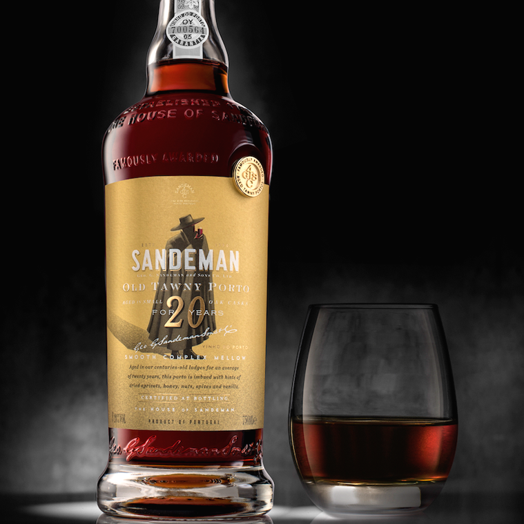 Load image into Gallery viewer, A bottle and a glass of Sandeman 20 year old port wine on a grey background