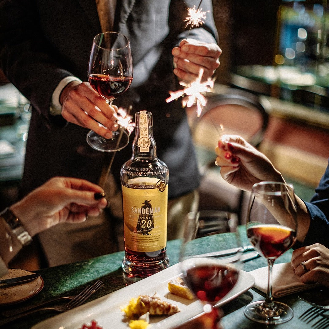 Load image into Gallery viewer, people are toasting with some port in their glasses and some sparkles in their hands