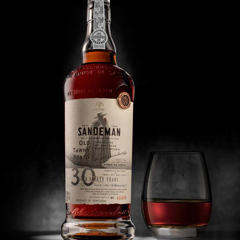 Load image into Gallery viewer, A bottle of aged port and a glass on a grey backgroun