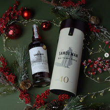 Load image into Gallery viewer, Sandeman Old Tawny Porto bottle and box on a festive green background with red berries and greenery.