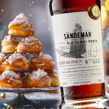 Load image into Gallery viewer, Sandeman Port bottle with a tower of pastries and a drizzled pastry on a festive background