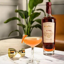 Load image into Gallery viewer, Bottle of Santa-Teresa-1796-Rum with a cocktail on a marble surface