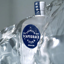 Load image into Gallery viewer, Scapegrace Vodka bottle with blue label on a gray background