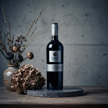 Load image into Gallery viewer, A bottle of Shingleback D Block Reserve Cabernet Sauvignon on a wooden surface with decorative elements.