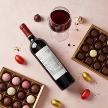 Load image into Gallery viewer, Bottle of Shingleback_The_Gate_Shiraz wine with a glass, surrounded by chocolates on a pink background