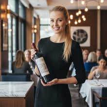 Load image into Gallery viewer, Woman holding a bottle of Shingleback_The_Gate_Shiraz wine in a restaurant setting