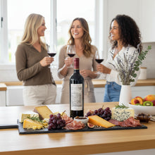 Load image into Gallery viewer, Three women enjoying Shingleback_The_Gate_Shiraz wine and a charcuterie board in a kitchen.