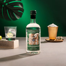 Load image into Gallery viewer, Sipsmith London Dry Gin bottle with a glass of gin and tonic on a green background