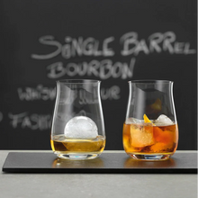 Load image into Gallery viewer, Two glasses of bourbon with ice cubes on a bar counter, with &#39;Single Barrel Bourbon&#39; text in the background.