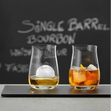 Load image into Gallery viewer, Two glasses of bourbon with ice cubes on a bar counter, with &#39;Single Barrel Bourbon&#39; text in the background.