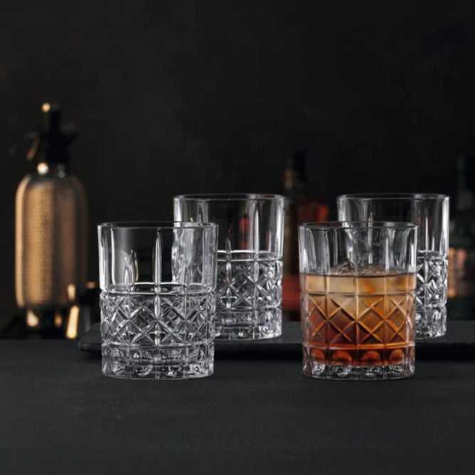 Load image into Gallery viewer, Set of clear glass tumblers with one containing whisky on a dark background