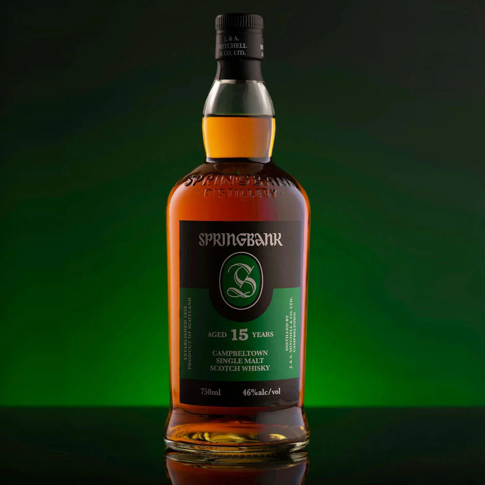 Springbank 15-year-old single malt Scotch whisky bottle on a green background
