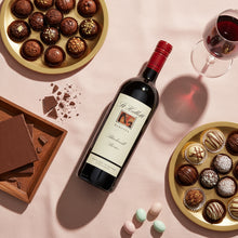 Load image into Gallery viewer, Bottle of St-Hallett-Blackwell-Shiraz wine with a label, surrounded by chocolates and a glass of red wine on a pink surface