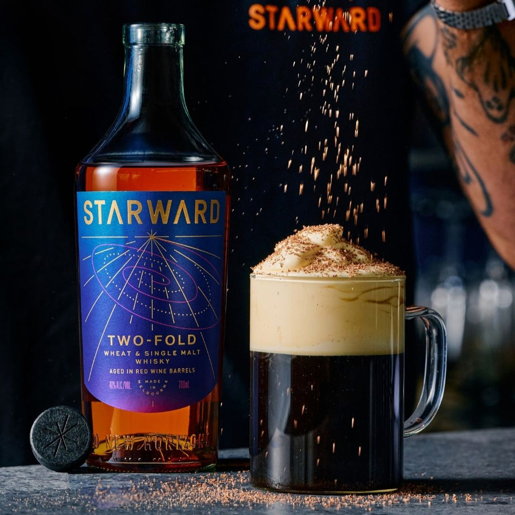 Starward Two-Fold whiskey bottle with a cocktail on a dark background