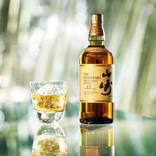 Load image into Gallery viewer, Bottle of Yamazaki whisky with a glass of whisky against a blurred natural background