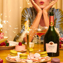 Load image into Gallery viewer, Woman celebrating with champagne and pastries at a table