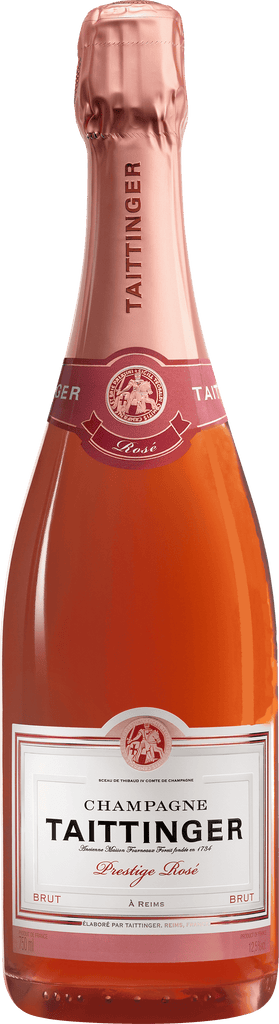 A bottle of Taittinger Prestige Rosé Champagne with a pink label and a shimmering red liquid visible through the transparent bottle.