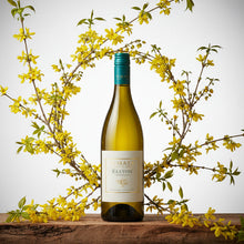 Load image into Gallery viewer, A bottle of A bottle of Te Mata Elston Chardonnay surrounded by yellow flowers
