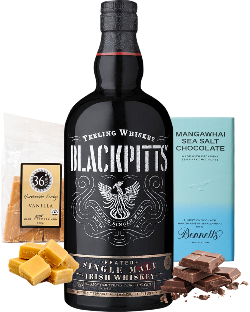 A bottle of Teeling Blackpitts Peated Single Malt Irish Whiskey centred on a white background, surrounded by flavour props: 36 Degrees vanilla fudge packet and vanilla fudge pieces, chocolate chunks, and a blue Bennett's Mangawhai Sea Salt Chocolate bar.