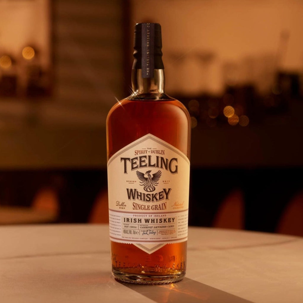 Teeling Single Grain Whiskey bottle on a bar counter with blurred bar background