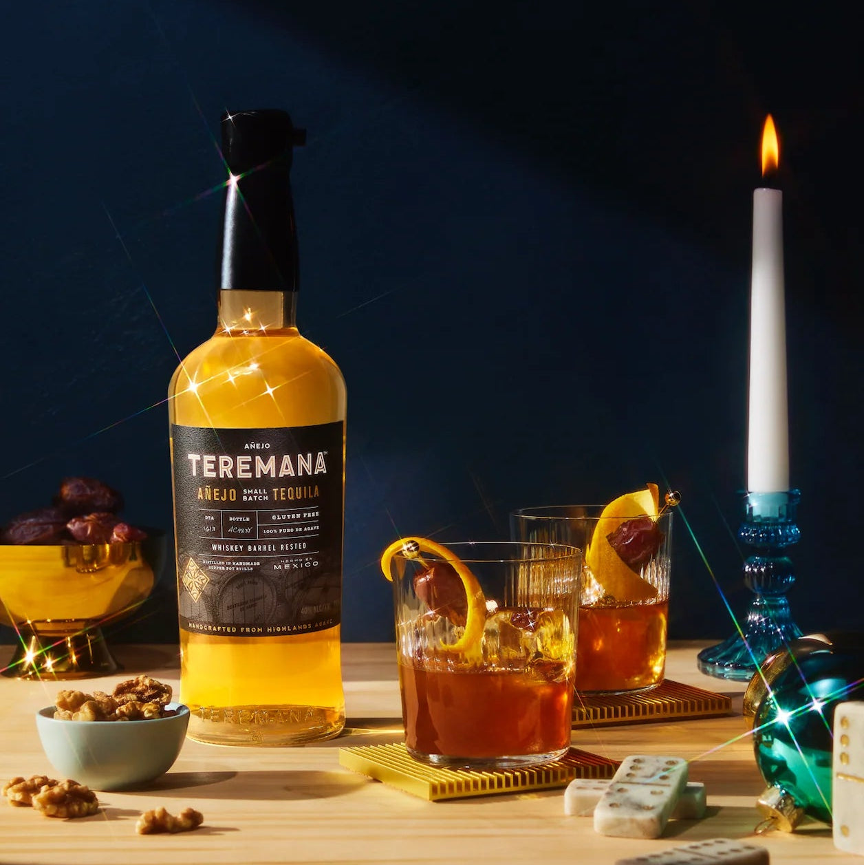 Load image into Gallery viewer, Bottle of Teremana anejo tequila on a table with a cocktail and decorative elements.