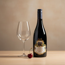 Load image into Gallery viewer, Terra-Sancta-Estate-Jacksons-Block-Pinot-Noir wine bottle with label, glass, and cherry on a wooden surface with a beige background