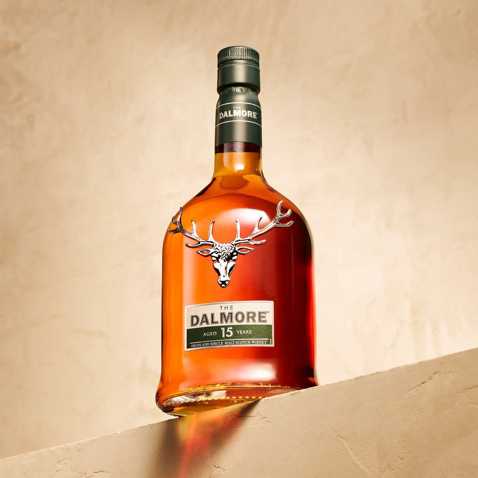 Load image into Gallery viewer, Bottle of Dalmore 15 year old whisky on a beige background