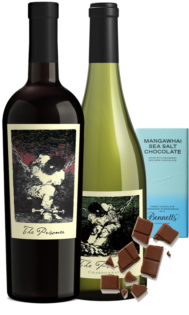 A wine gift set featuring a bottle of The Prisoner Californian Red Blend and Chardonnay white wine, alongside a blue package of Bennett's Mangawhai Sea Salt Chocolate and scattered chocolate pieces on a white background.