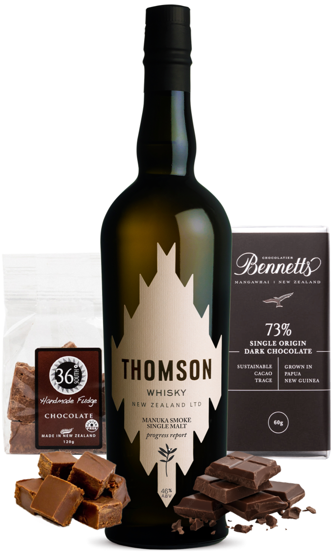 Load image into Gallery viewer, A bottle of Thomson Manuka Smoke Whisky, a bag of 36 Degrees chocolate fudge, a bar of Bennett's 73% dark chocolate, and scattered chocolate pieces in front.