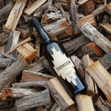Load image into Gallery viewer, Thomson Manuka Whisky on a bed of wooden logs