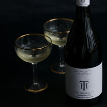 Load image into Gallery viewer, Wine bottle with two glasses on a dark background, featuring a silver medal award on the right.