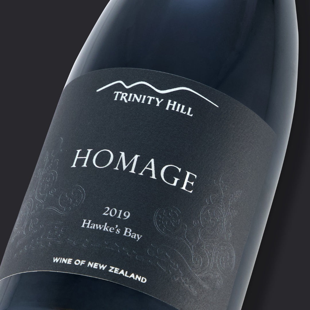 Wine bottle labeled 'Homage' by Trinity Hill with a dark background