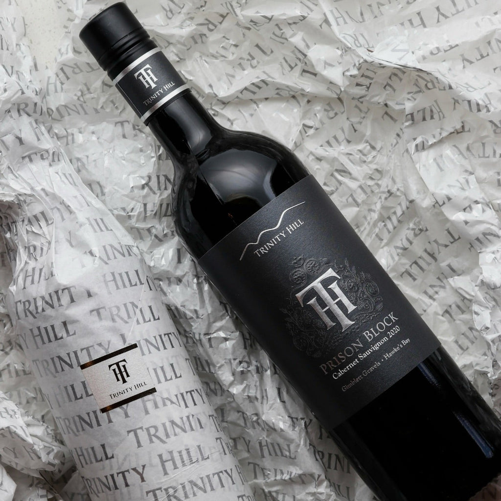 Trinity Hill Prison Block Cabernet Sauvignon wine bottle on tissue paper with visible branding.