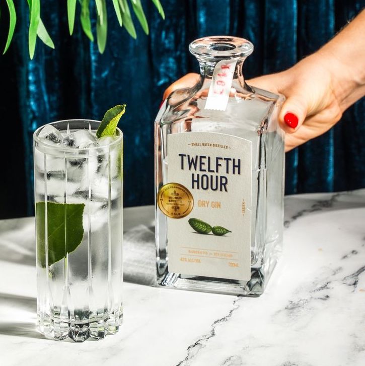 An image of a Twelfth Hour Dry Gin 700ml next to a delicious gin and tonic cocktail