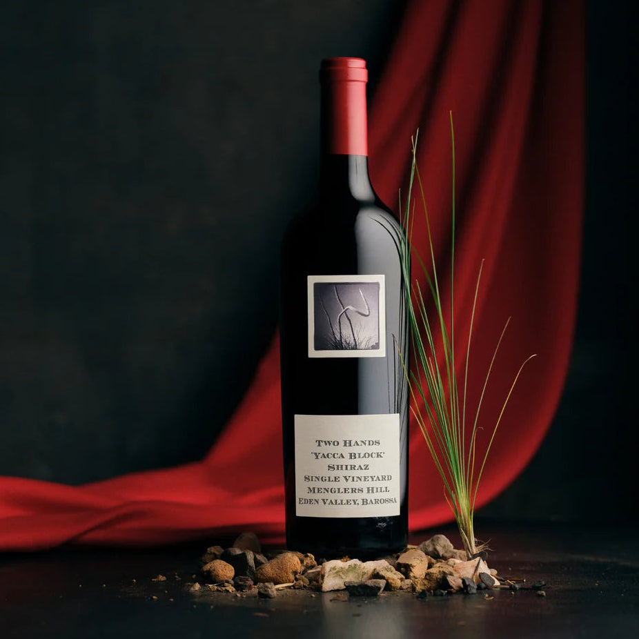 Load image into Gallery viewer, Two Hands Yacca Block Shiraz red wine bottle with a label on a dark background with red fabric