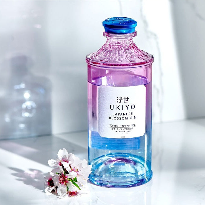 Load image into Gallery viewer, Bottle of Ukiyo Blossom gin with a cherry blossom flower on a white background