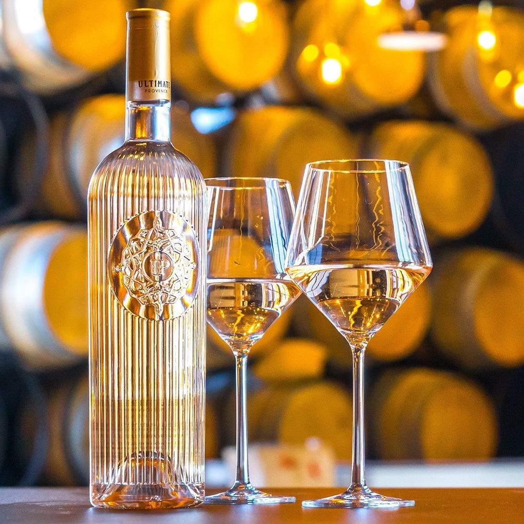 Load image into Gallery viewer, Wine bottle and glasses with barrels in the background