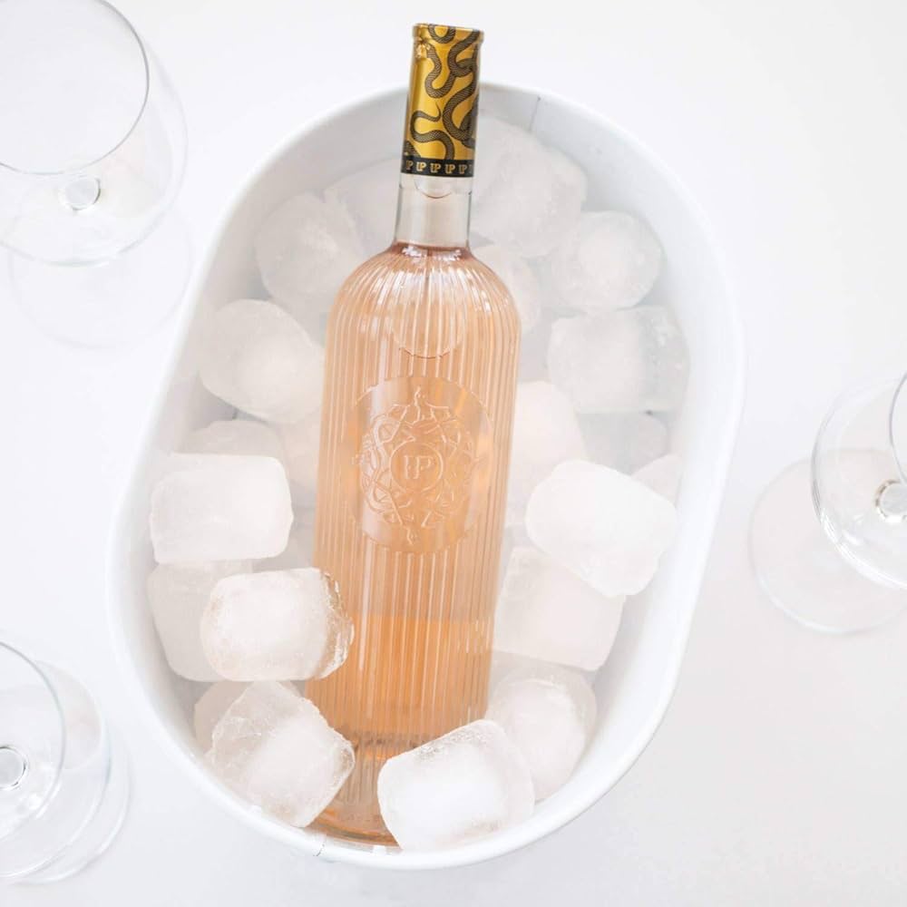 Load image into Gallery viewer, Bottle of rosé wine in a bowl of ice with glasses on a white background