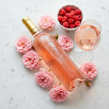 Load image into Gallery viewer, Bottle of ULTIMATE PROVENCE rose wine with a glass, raspberries, and pink flowers on a marble surface