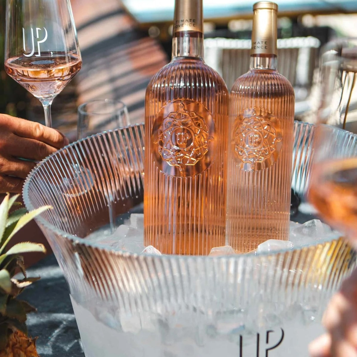 Load image into Gallery viewer, Two bottles of rose wine in an ice bucket with glasses nearby, featuring the brand 'UP'.