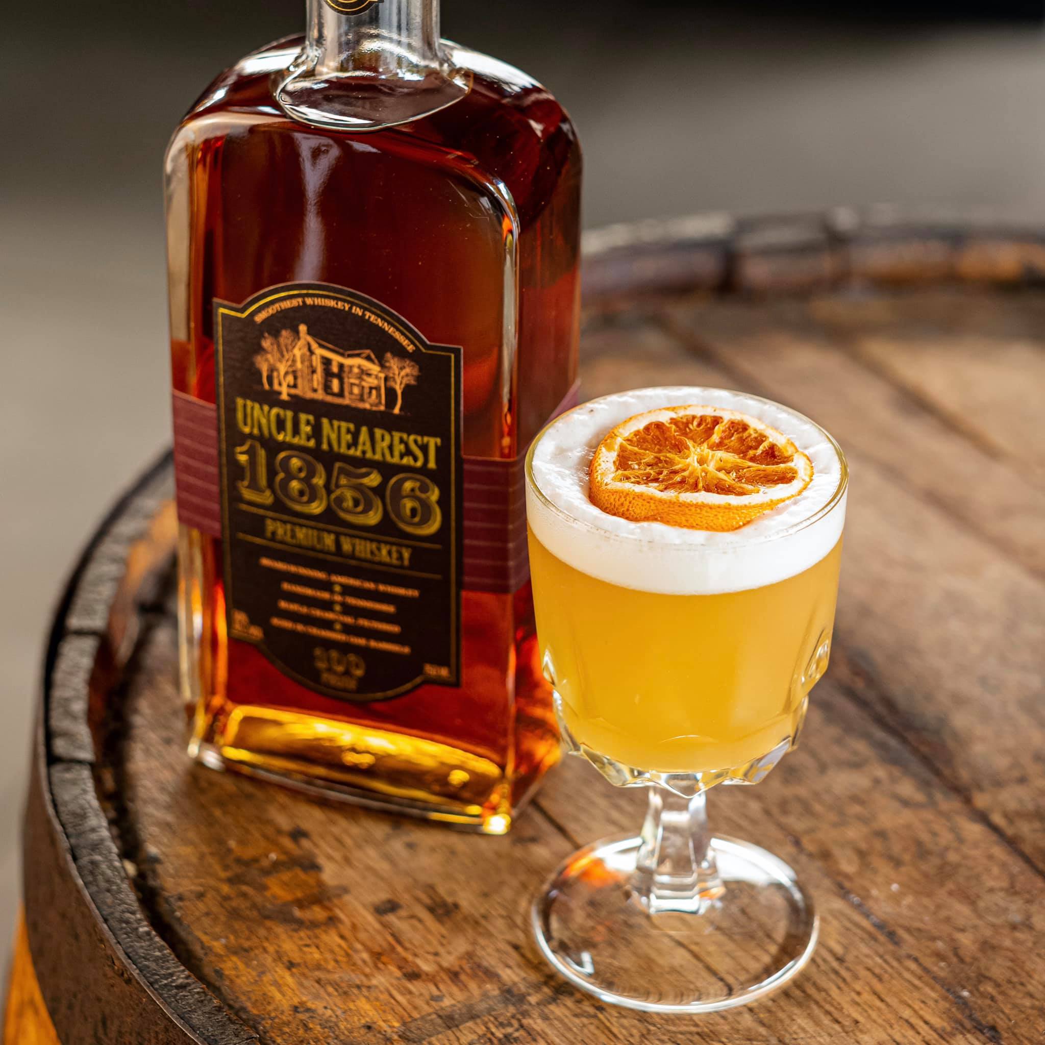 Load image into Gallery viewer, Whiskey bottle and cocktail on a wooden barrel