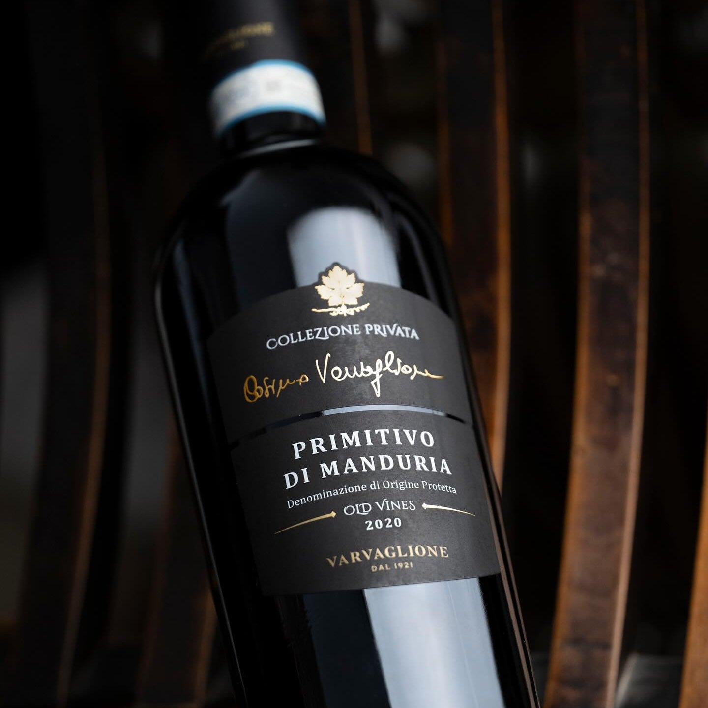 Load image into Gallery viewer, Varvaglione Cosimo Collezione Privata Primitivo red wine bottle with a dark label on a wooden background