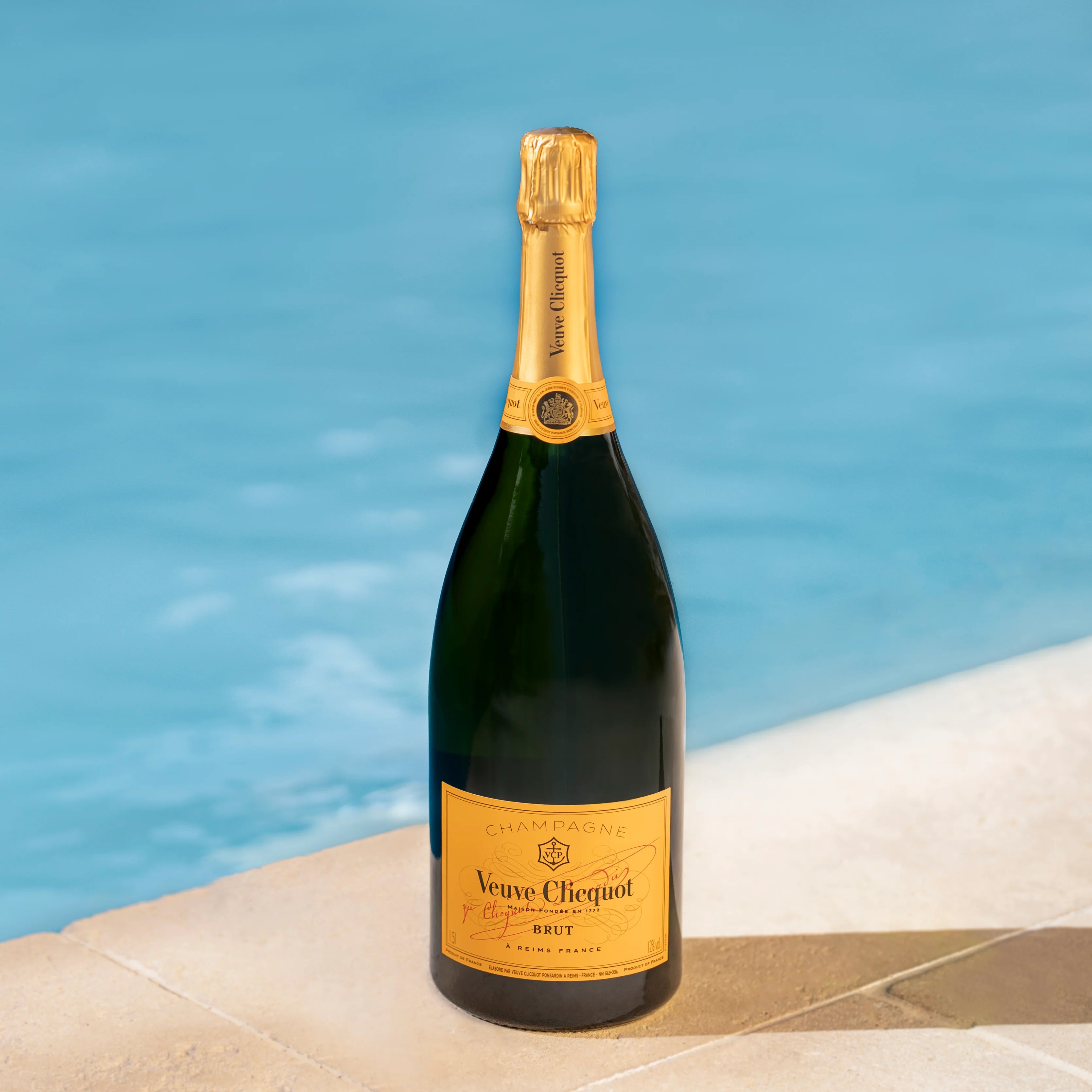 Load image into Gallery viewer, Bottle of Veuve Clicquot champagne Magnum 1500ml bottle by a pool