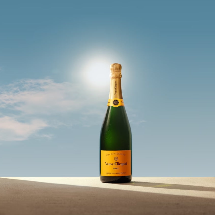 Load image into Gallery viewer, A bottle of Veuve Clicquot Brut Champagne with a blur sky i n the background