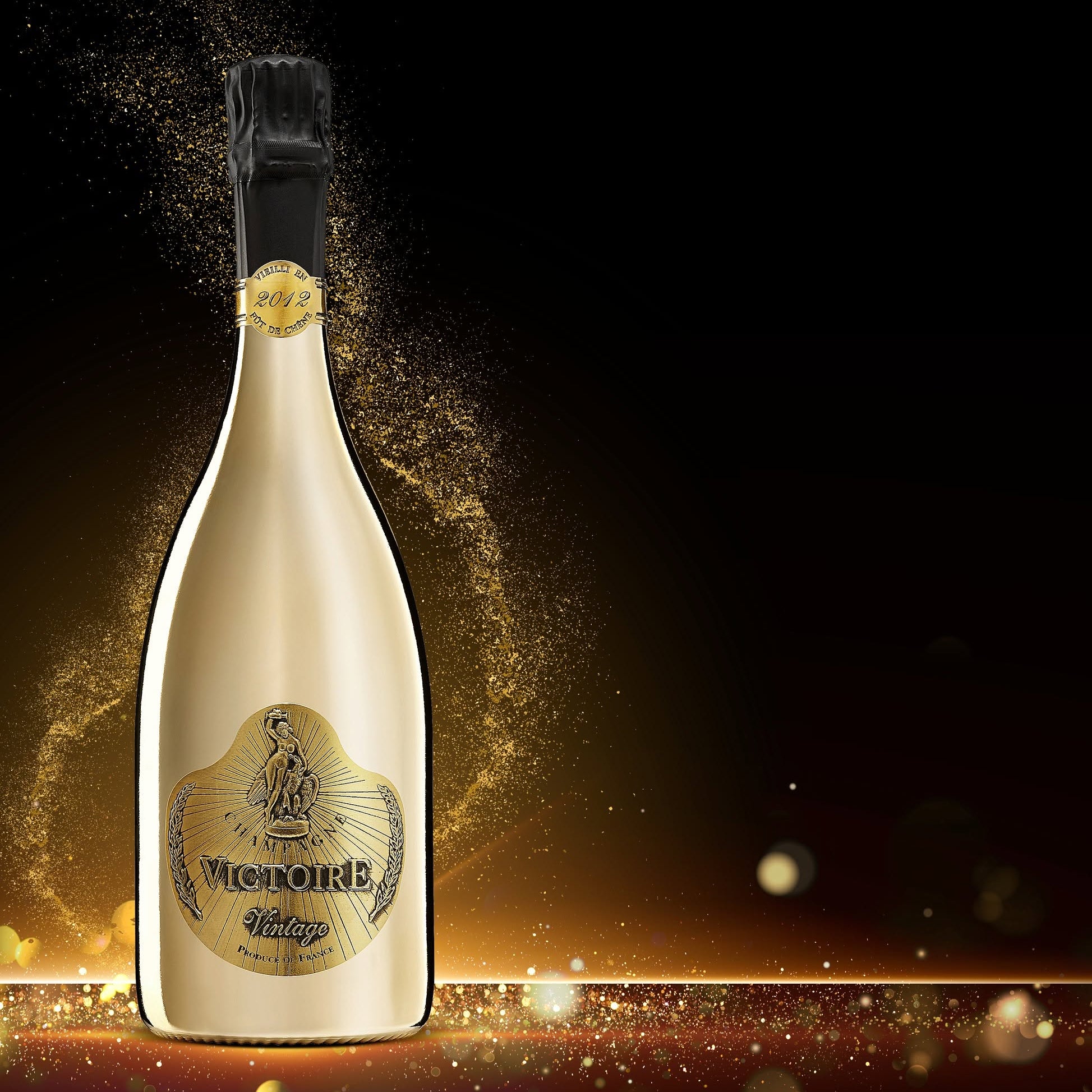 Load image into Gallery viewer, A bottle of Victoire Fût de Chêne Prestige Champagne, set against a dark background with golden sparkling effects and light leaks.